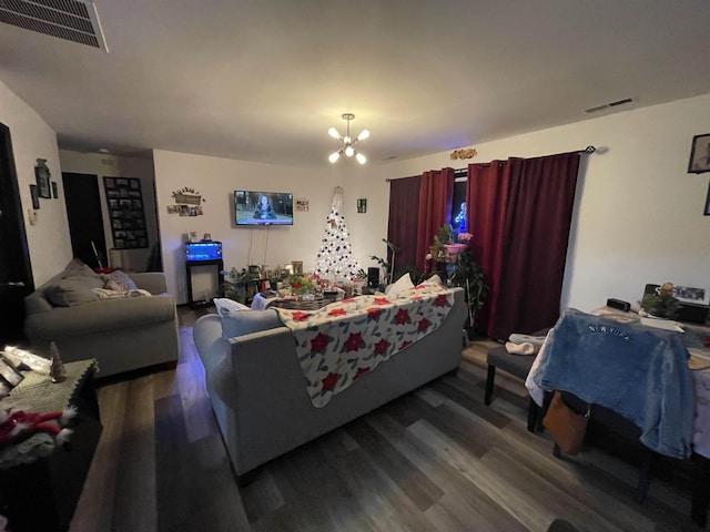 living room with an inviting chandelier and dark hardwood / wood-style floors