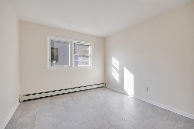 tiled spare room with baseboard heating