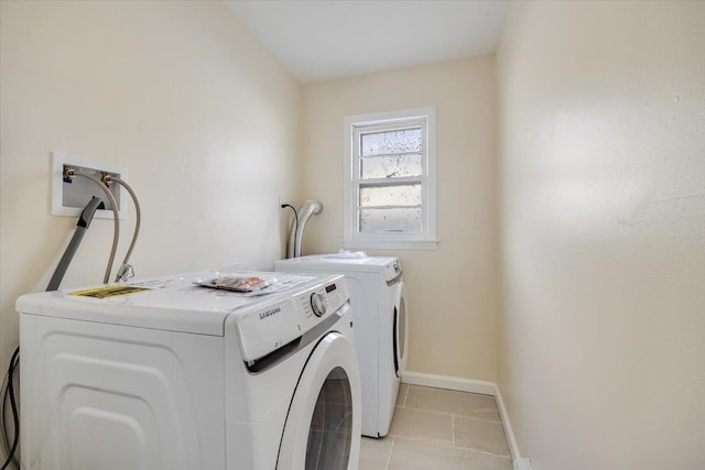 laundry room featuring washer and clothes dryer and light tile patterned flooring