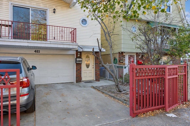 view of property featuring a garage and a balcony