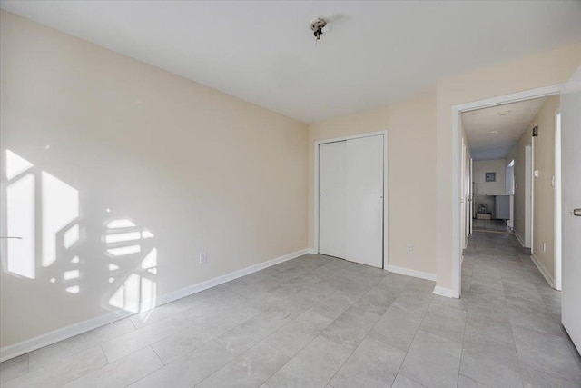 unfurnished bedroom featuring a closet and light tile patterned floors