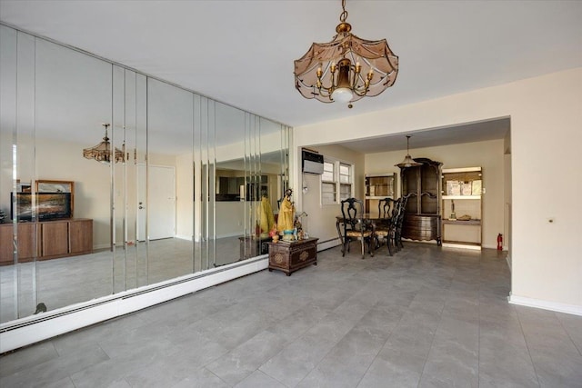 interior space with a chandelier and baseboard heating