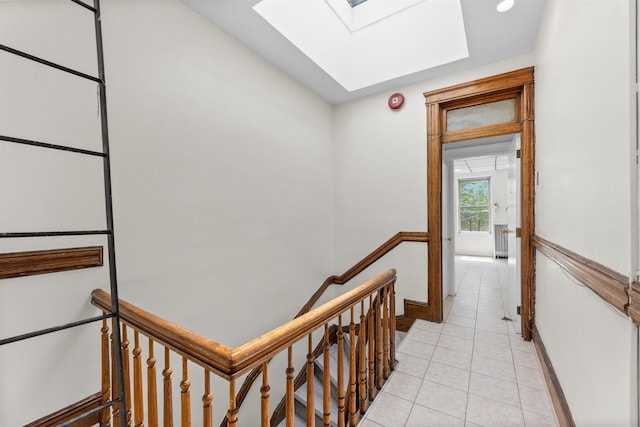 337 70th St, Guttenberg, NJ 07093 - hall featuring a skylight, an upstairs landing, light tile patterned floors, and baseboards