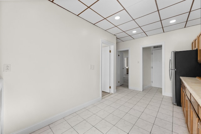 337 70th St, Guttenberg, NJ 07093 - kitchen with freestanding refrigerator, baseboards, light countertops, recessed lighting, and brown cabinetry