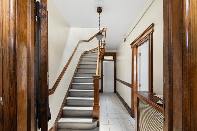 337 70th St, Guttenberg, NJ 07093 - stairway featuring tile patterned floors and baseboards