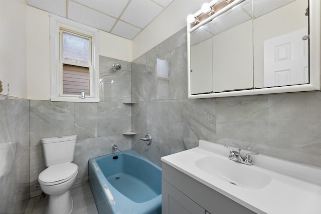 337 70th St, Guttenberg, NJ 07093 - full bathroom featuring tile walls, toilet, vanity, a drop ceiling, and  shower combination