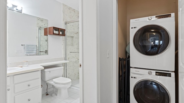 344 The Promenade Unit 344, Edgewater, NJ 07020 - interior space featuring stacked washer / drying machine, vanity, toilet, tile patterned floors, and a stall shower
