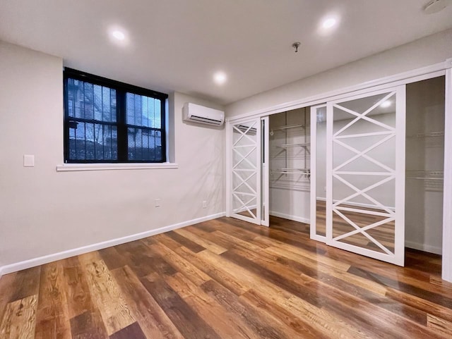 43 Van Wagenen Ave Unit Ga, Jersey City, NJ 07306 - unfurnished bedroom featuring a wall mounted air conditioner, wood finished floors, and recessed lighting