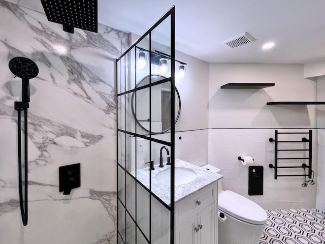 43 Van Wagenen Ave Unit Ga, Jersey City, NJ 07306 - bathroom featuring tile walls, vanity, a marble finish shower, and tile patterned flooring