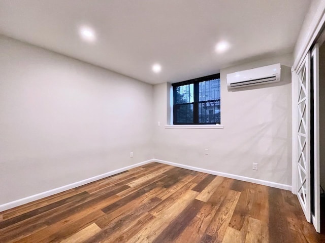43 Van Wagenen Ave Unit Ga, Jersey City, NJ 07306 - unfurnished bedroom with a wall mounted air conditioner, wood finished floors, and recessed lighting