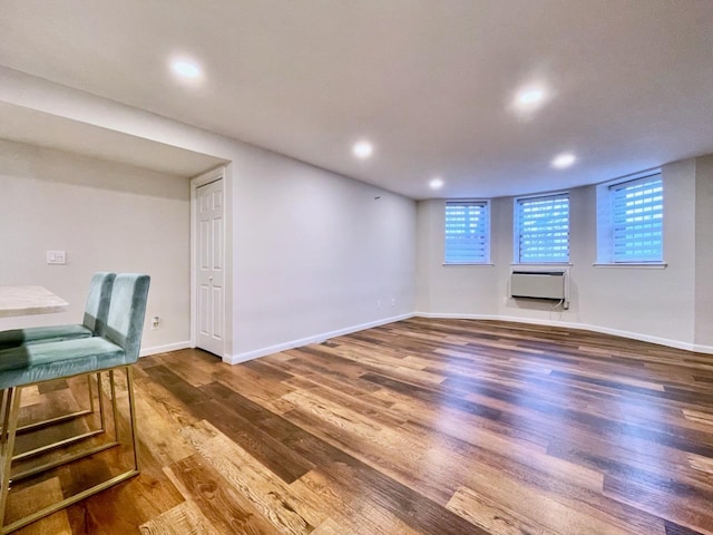 43 Van Wagenen Ave Unit Ga, Jersey City, NJ 07306 - below grade area with wood finished floors, an AC wall unit, recessed lighting, and plenty of natural light