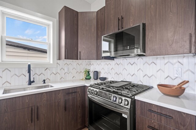 28 Cambridge Ave Unit 2, Jersey City, NJ 07307 - kitchen featuring dark brown cabinets, backsplash, a sink, and stainless steel appliances
