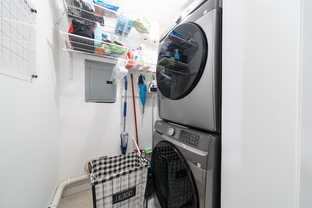 456 9th St Unit 458, Hoboken, NJ 07030 - laundry room with stacked washer and clothes dryer, electric panel, and tile patterned flooring