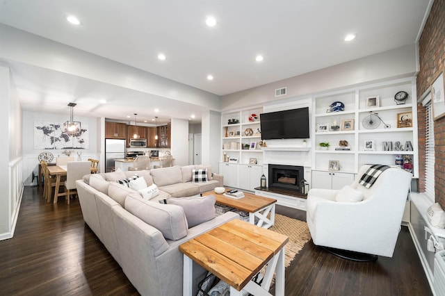 456 9th St Unit 458, Hoboken, NJ 07030 - living room with dark wood finished floors, recessed lighting, a fireplace with raised hearth, and built in features