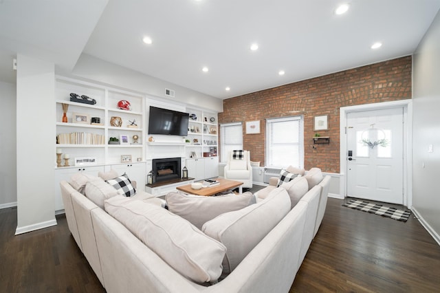 456 9th St Unit 458, Hoboken, NJ 07030 - living area with brick wall, dark wood finished floors, a fireplace with raised hearth, and recessed lighting