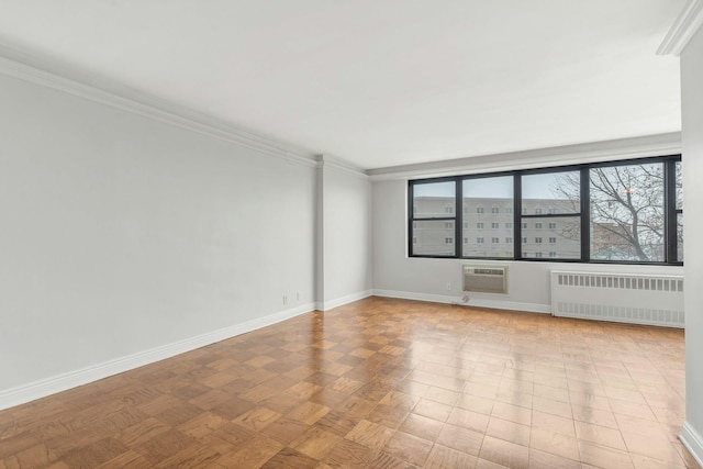 unfurnished room featuring an AC wall unit, radiator heating unit, crown molding, and light parquet flooring