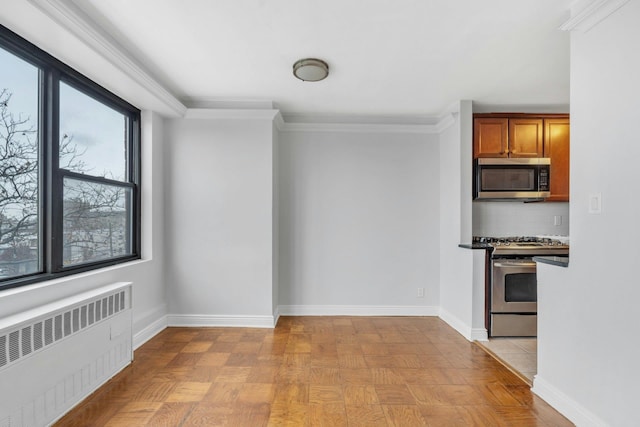 unfurnished dining area featuring radiator heating unit, ornamental molding, and light parquet floors