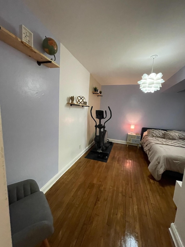 bedroom with dark hardwood / wood-style floors