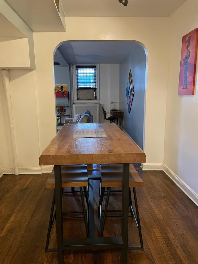 dining area with dark hardwood / wood-style flooring