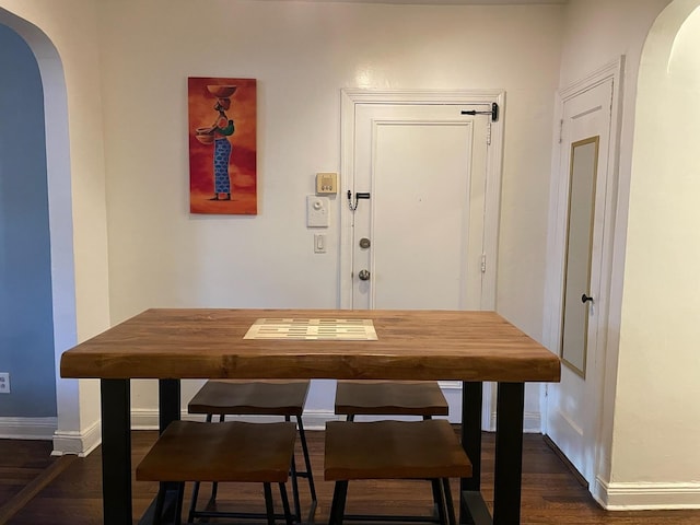 dining space featuring dark wood-type flooring