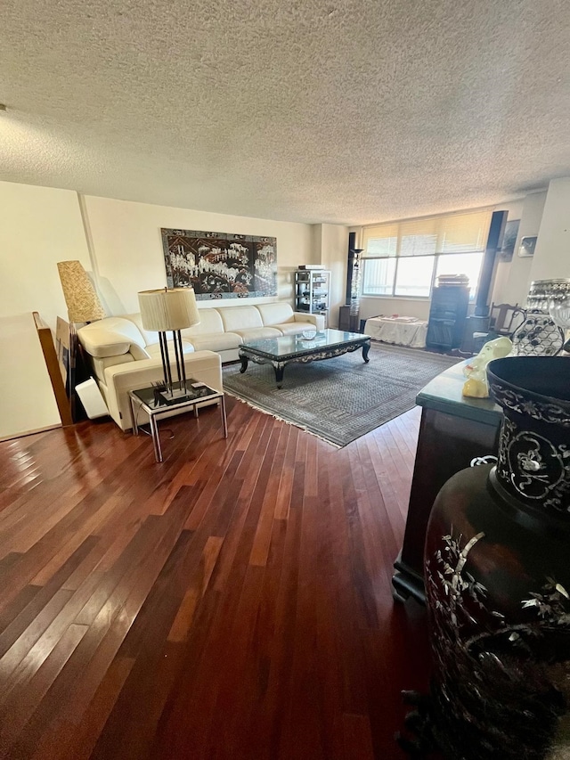 living room with a textured ceiling and hardwood / wood-style floors