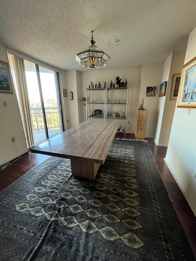 dining room with floor to ceiling windows, dark wood-style floors, a chandelier, and a textured ceiling