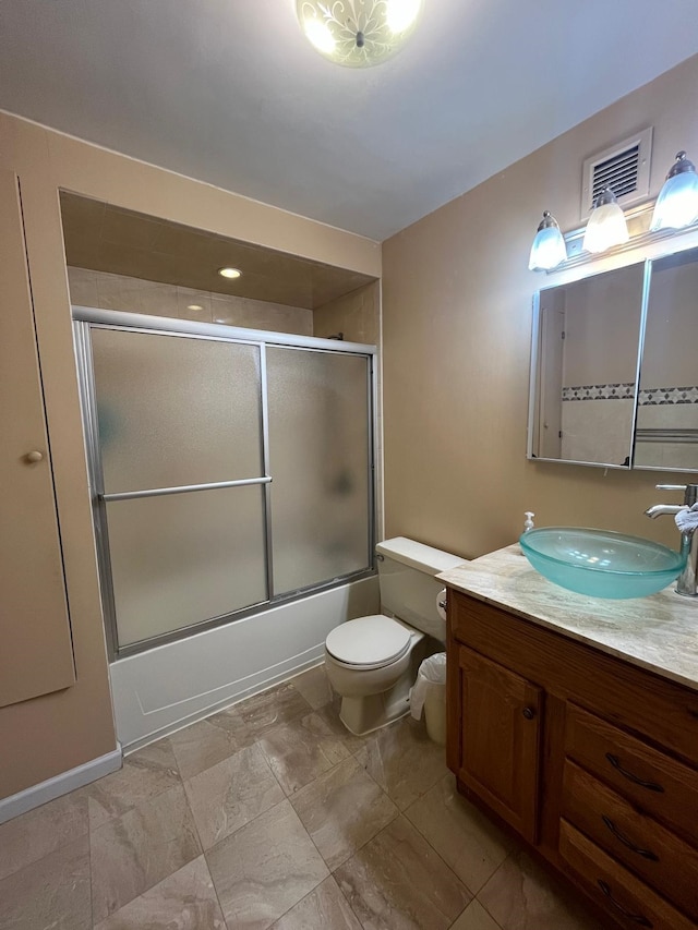 bathroom featuring vanity, toilet, visible vents, and shower / bath combination with glass door