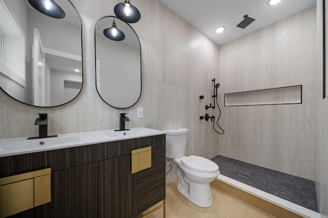 45 Graham St Unit 1, Jersey City, NJ 07307 - bathroom with double vanity, tiled shower, tile patterned floors, and recessed lighting