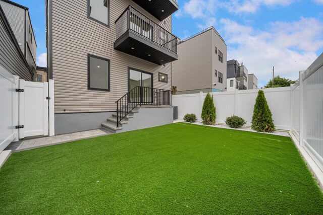 45 Graham St Unit 1, Jersey City, NJ 07307 - rear view of house featuring a balcony, a gate, and a fenced backyard