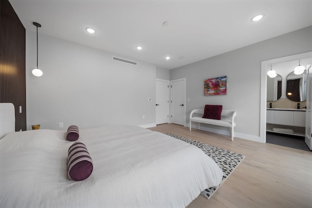 45 Graham St Unit 1, Jersey City, NJ 07307 - bedroom featuring wood finished floors, recessed lighting, and connected bathroom