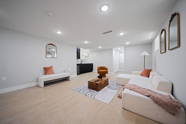 45 Graham St Unit 1, Jersey City, NJ 07307 - living area with bar with sink, recessed lighting, and light wood-style flooring