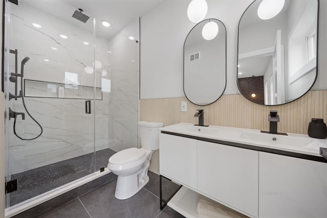 45 Graham St Unit 1, Jersey City, NJ 07307 - bathroom with a wainscoted wall, double vanity, a marble finish shower, and tile patterned floors