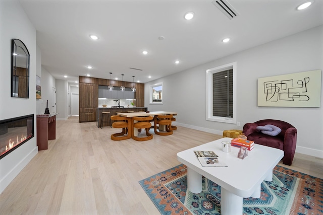 45 Graham St Unit 1, Jersey City, NJ 07307 - living area with light wood-style flooring, recessed lighting, and a glass covered fireplace