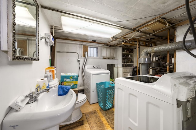 laundry area with washer and clothes dryer and wood finished floors