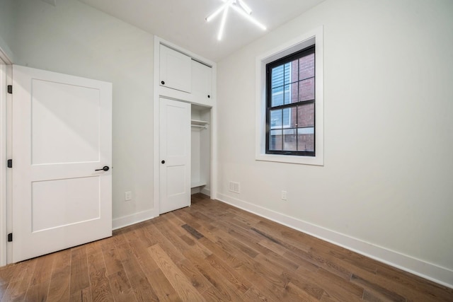 545 Palisade Ave Unit 2, Jersey City, NJ 07307 - unfurnished bedroom featuring wood finished floors, baseboards, and a closet