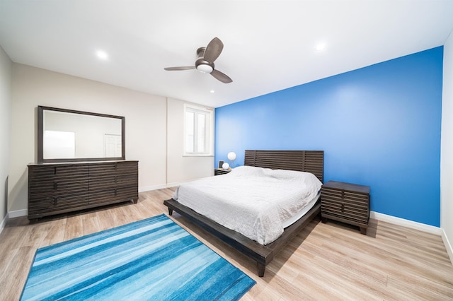 bedroom featuring light wood-type flooring and ceiling fan