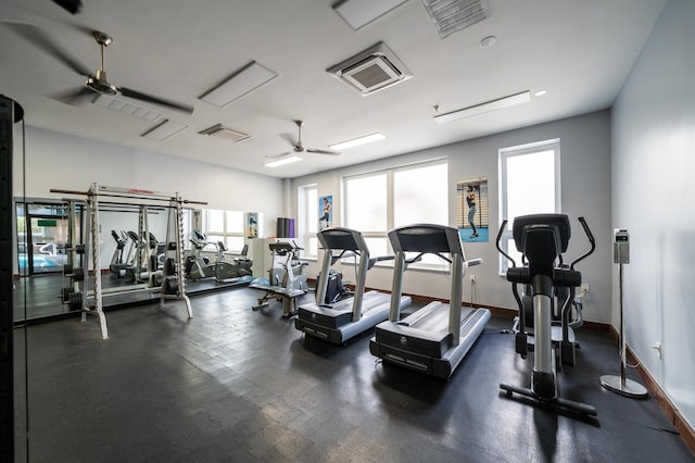 workout area with ceiling fan and a healthy amount of sunlight