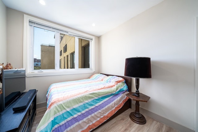 bedroom with hardwood / wood-style flooring