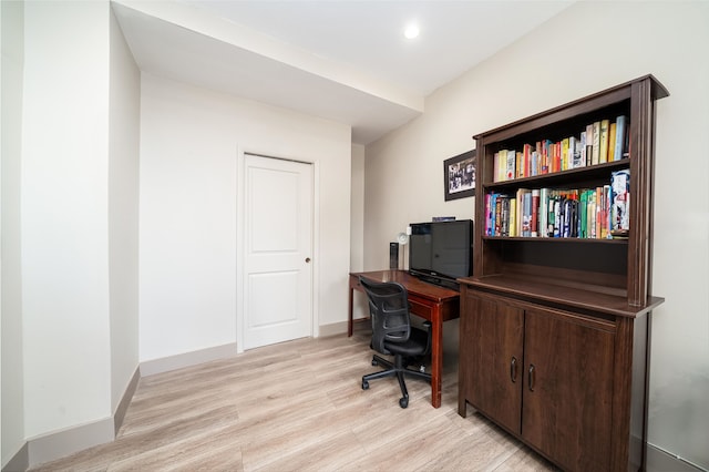 home office with light hardwood / wood-style flooring