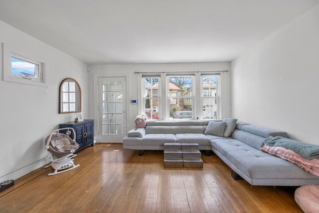 living area with a wood stove and hardwood / wood-style floors