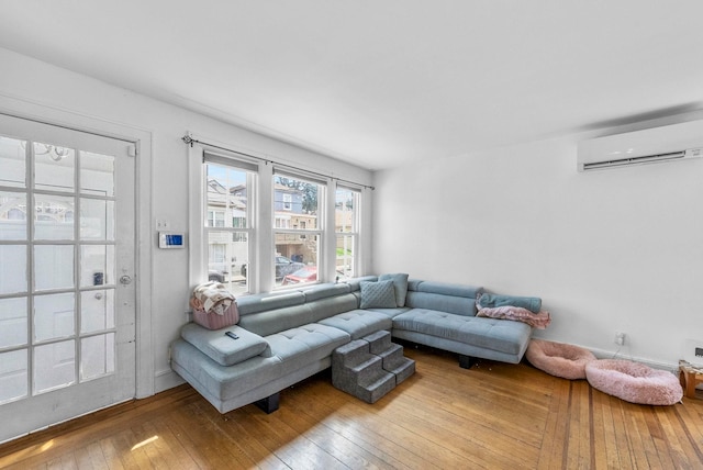 living room featuring hardwood / wood-style floors and a wall mounted air conditioner