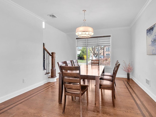 183 Oak Ave, River Edge, NJ 07661 - dining area with baseboards, ornamental molding, wood finished floors, and stairway