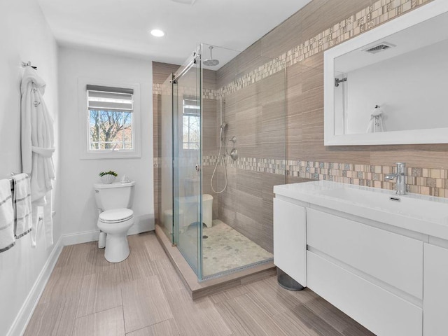 183 Oak Ave, River Edge, NJ 07661 - full bath with a stall shower, toilet, baseboards, vanity, and decorative backsplash