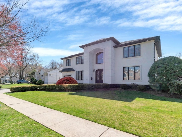 183 Oak Ave, River Edge, NJ 07661 - view of front of home with a front yard, stucco siding, and french doors
