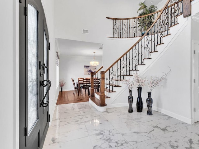 183 Oak Ave, River Edge, NJ 07661 - foyer entrance featuring marble finish flooring, healthy amount of natural light, stairs, baseboards, and a high ceiling