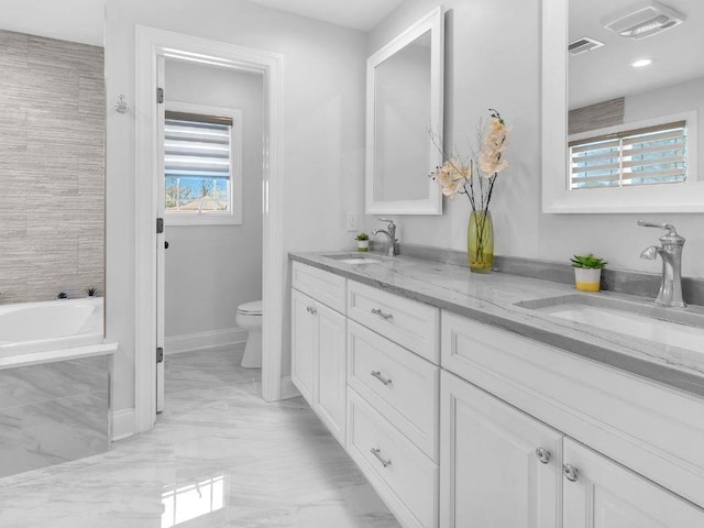 183 Oak Ave, River Edge, NJ 07661 - bathroom with toilet, marble finish floors, double vanity, a tub, and baseboards