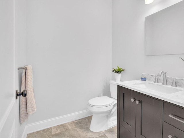 183 Oak Ave, River Edge, NJ 07661 - half bathroom featuring baseboards, vanity, and toilet