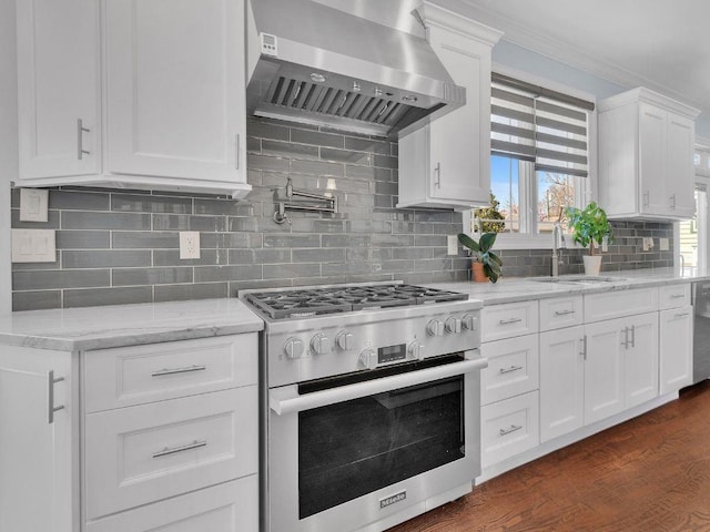 183 Oak Ave, River Edge, NJ 07661 - kitchen featuring stainless steel appliances, wall chimney range hood, a sink, white cabinets, and dark wood-style floors