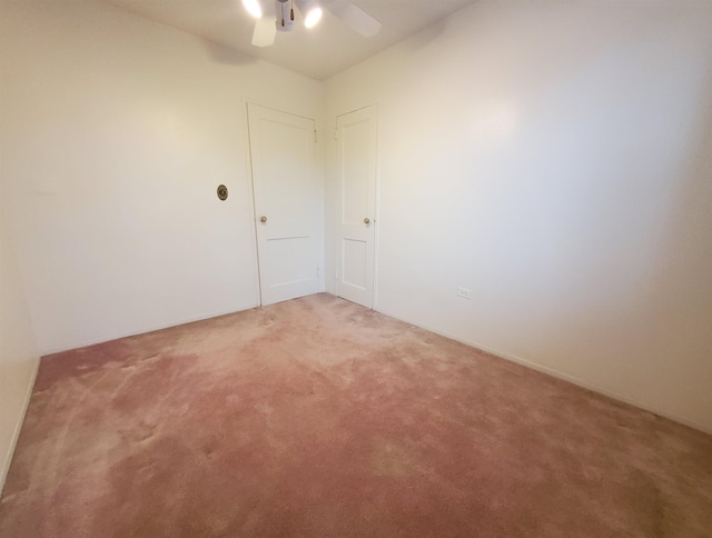 spare room featuring carpet floors and ceiling fan