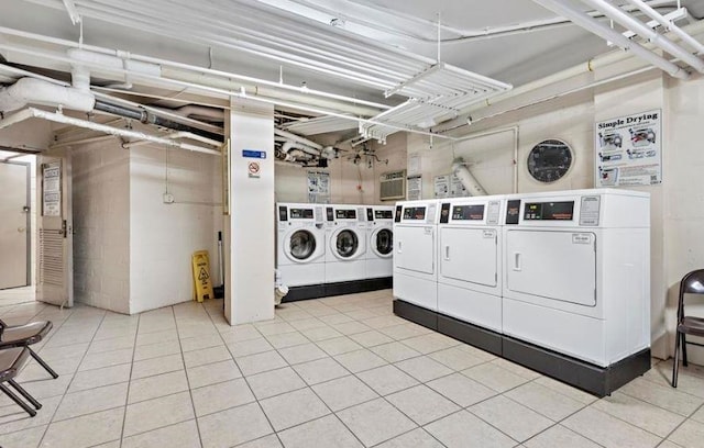 washroom featuring washing machine and dryer and tile patterned flooring